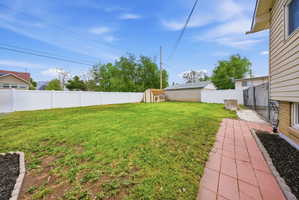 Fenced backyard with a storage shed