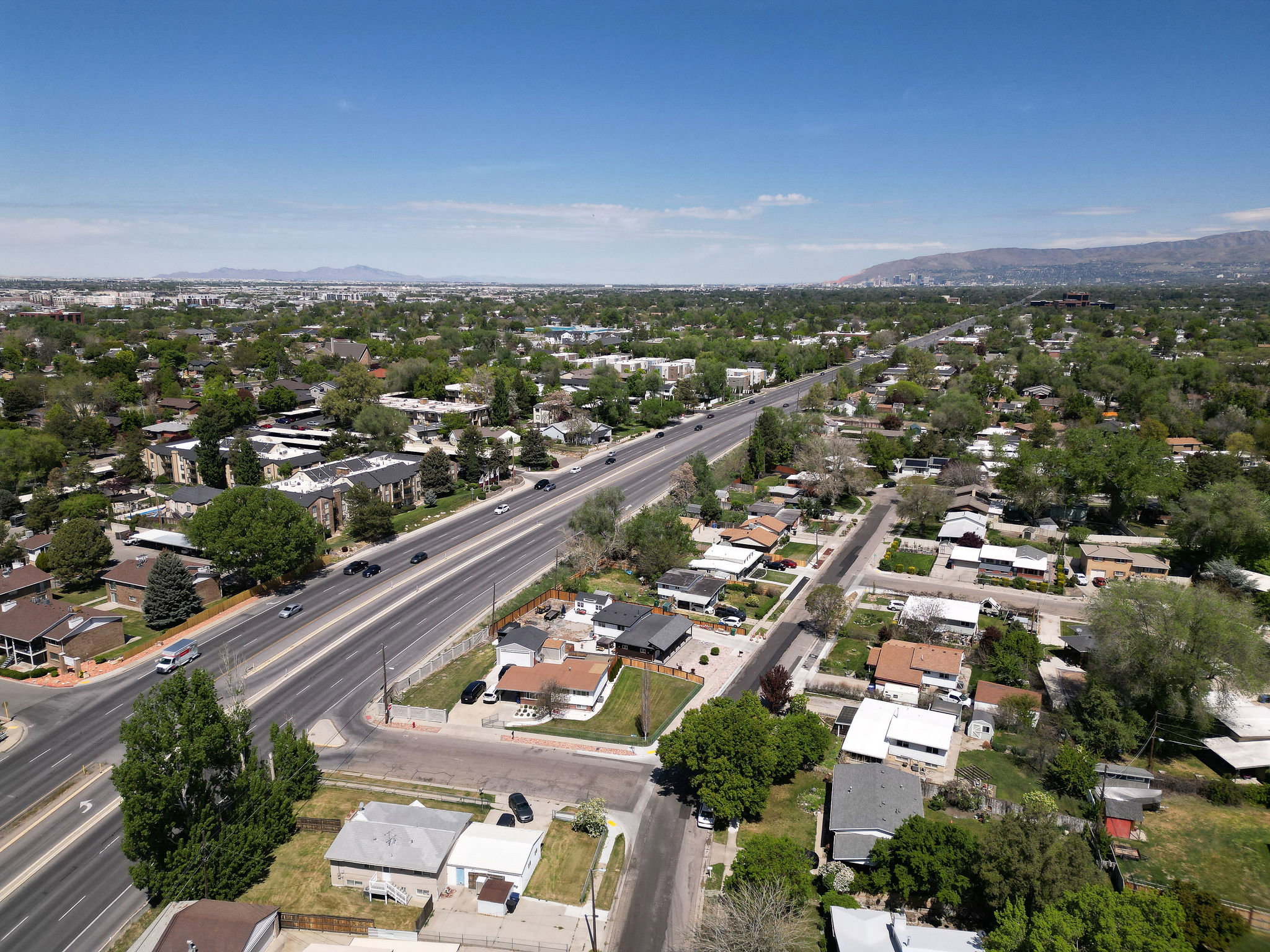 Aerial view of property's location with a mountain backdrop and nearby suburban area