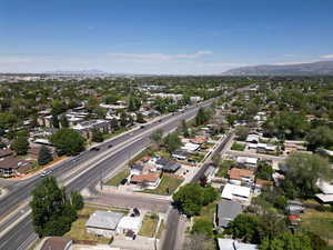 Aerial view of property's location with a mountain backdrop and nearby suburban area