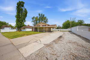 View of front facade featuring driveway and a porch