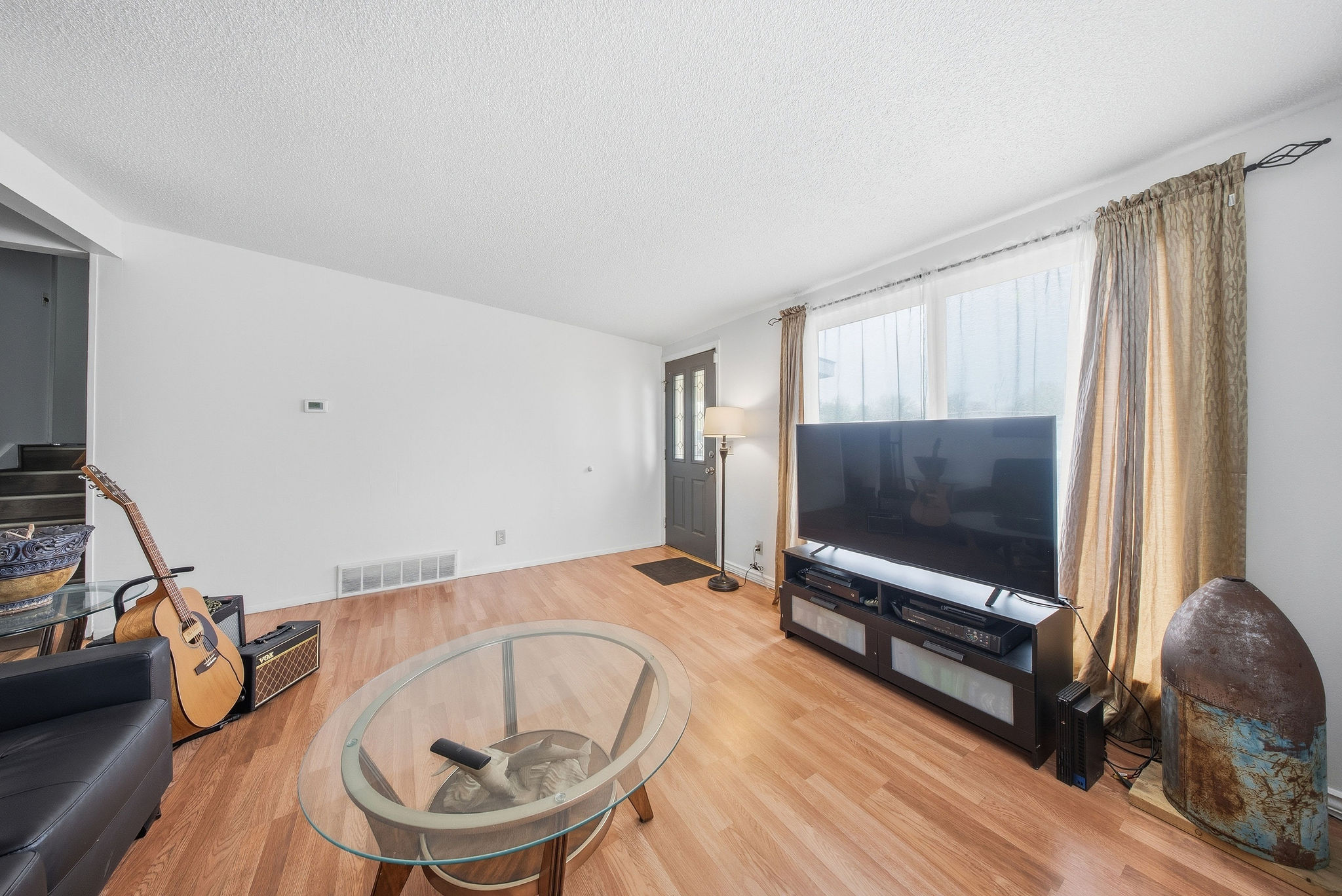Living room featuring a textured ceiling and light wood finished floors