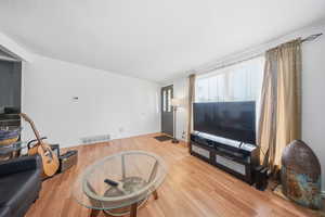 Living room featuring a textured ceiling and light wood finished floors
