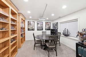 Den family room area with hidden closets and extra storage behind bookshelves