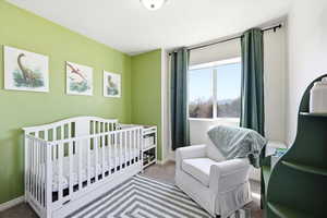 Bedroom with carpet floors and a crib