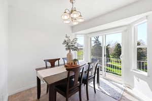 Dining space with baseboards and suspended lighting