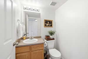 Bathroom with vanity and a textured ceiling