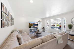 Living area featuring carpet floors and recessed lighting