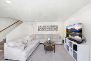 Living area featuring light carpet and recessed lighting