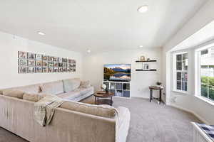 Living area with carpet flooring and recessed lighting