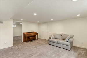 Living area with recessed lighting and carpet flooring