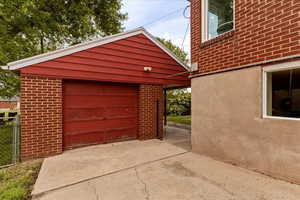 Detached garage featuring concrete driveway
