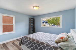 Bedroom featuring light wood finished floors and baseboards