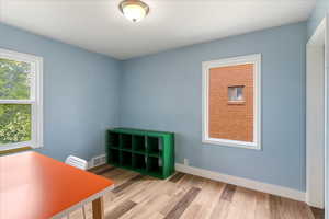 Unfurnished office featuring light wood-style floors and baseboards