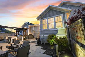 Patio terrace at dusk with a fenced backyard, area for grilling, a patio, and a pergola