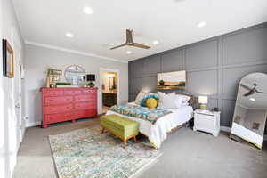 Bedroom with a decorative wall, recessed lighting, crown molding, light carpet, and connected bathroom