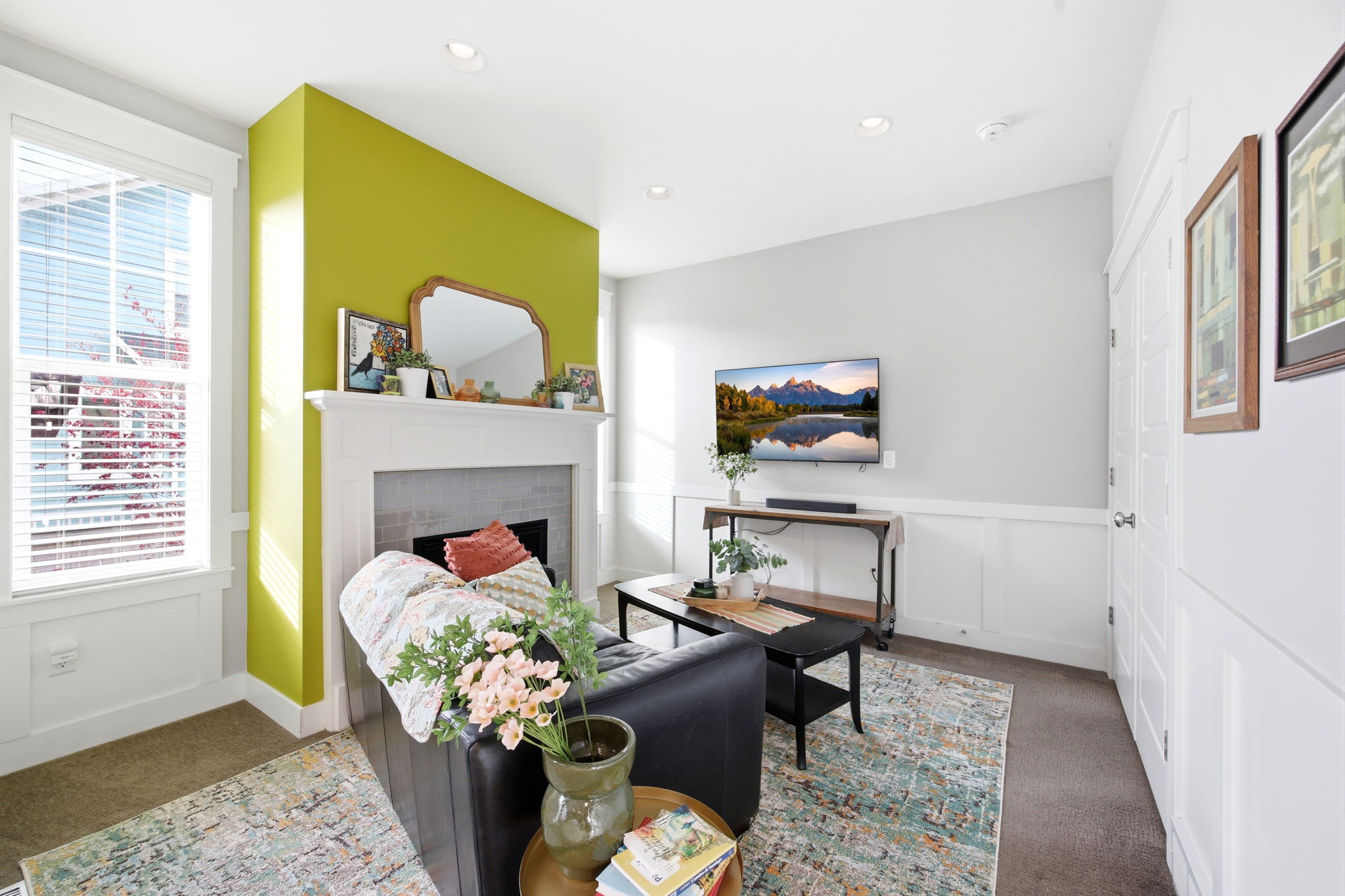 Carpeted bedroom featuring a decorative wall, a fireplace, recessed lighting, and wainscoting