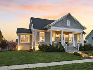 View of front of home with a porch and roof with shingles