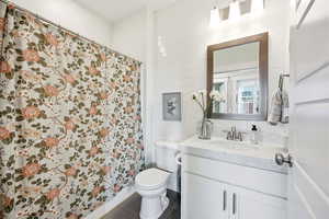 Full bath featuring vanity and a shower with curtain