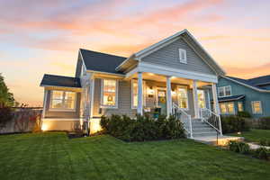 View of front of property with covered porch and roof with shingles