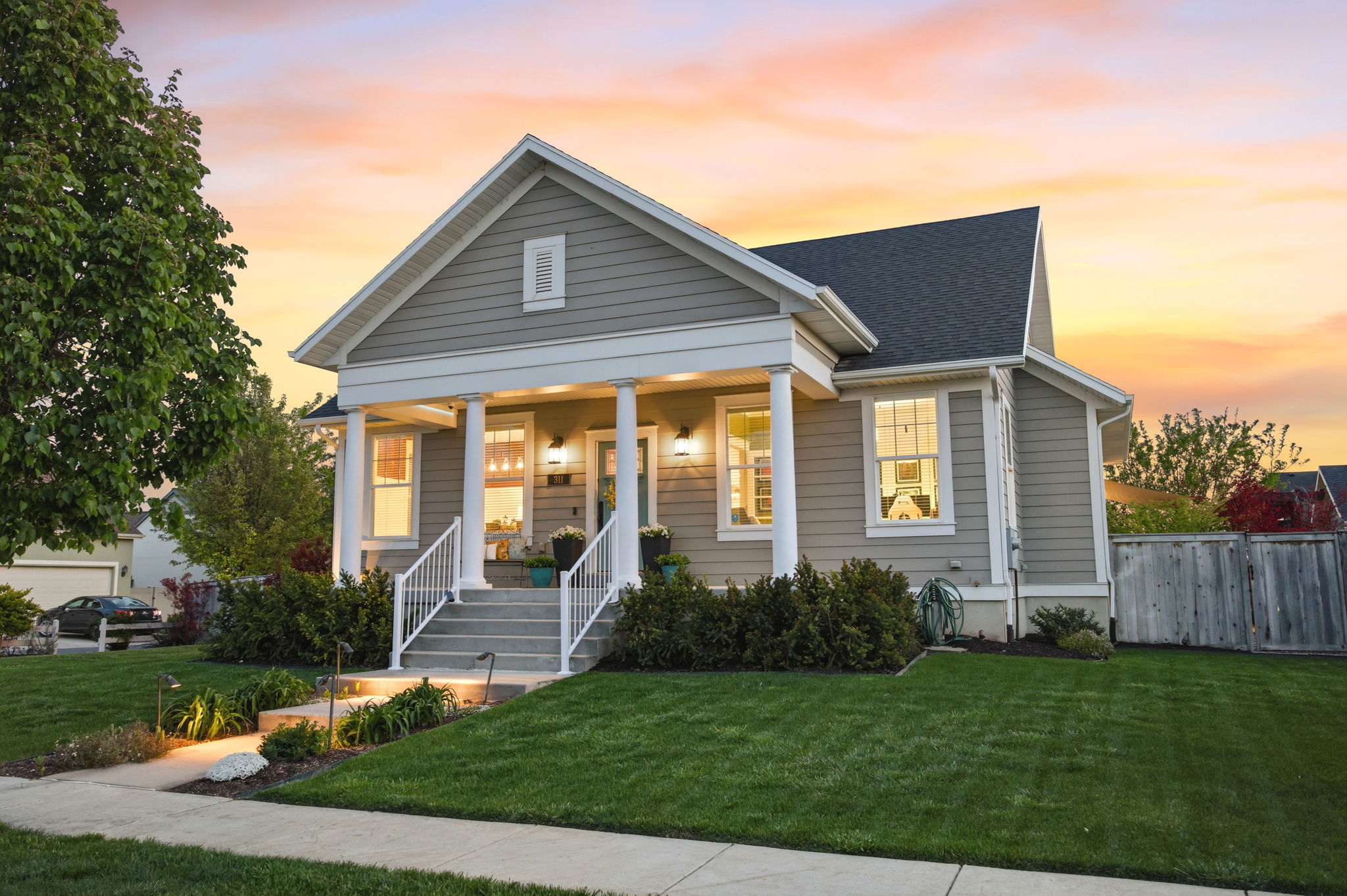 View of front of house with covered porch and a shingled roof