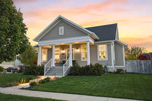 View of front of house with covered porch and a shingled roof