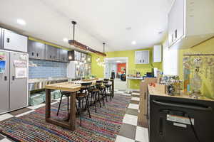 Dining area featuring dark floors and recessed lighting