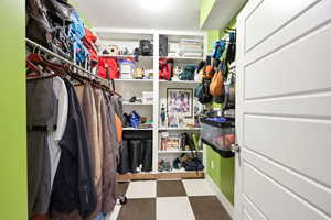 Walk in closet with dark flooring