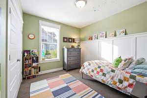 Carpeted bedroom with baseboards