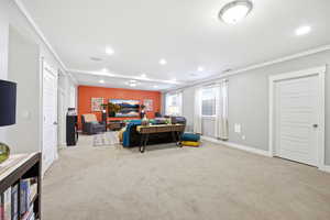 Living area with crown molding, light carpet, and recessed lighting