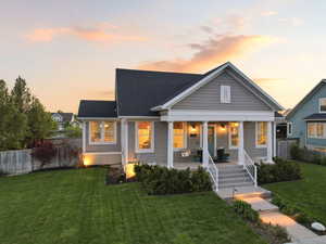 Bungalow featuring covered porch and a shingled roof