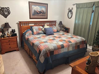 Bedroom featuring light carpet