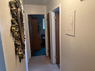 Hallway featuring electric panel