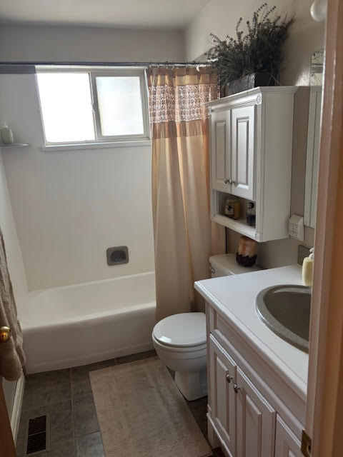 Full bath featuring vanity and shower / tub combo with curtain