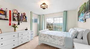 Bedroom featuring light carpet