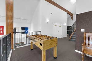 Playroom with vaulted ceiling and carpet floors