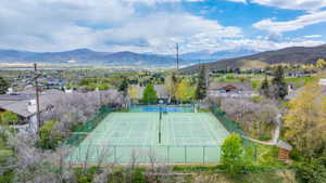 View of tennis court with a mountain view