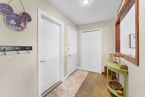 Entrance foyer featuring dark stone finish flooring and baseboards