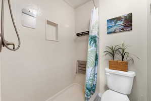 Bathroom with a stall shower and toilet
