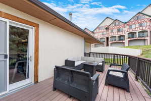 Wooden deck featuring a side sliding glass door.
