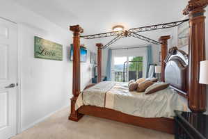 Bedroom featuring light colored carpet and access to outside