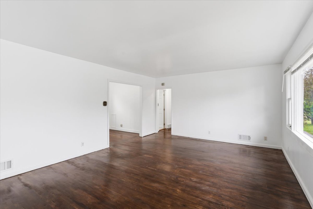 Unfurnished room featuring dark wood finished floors