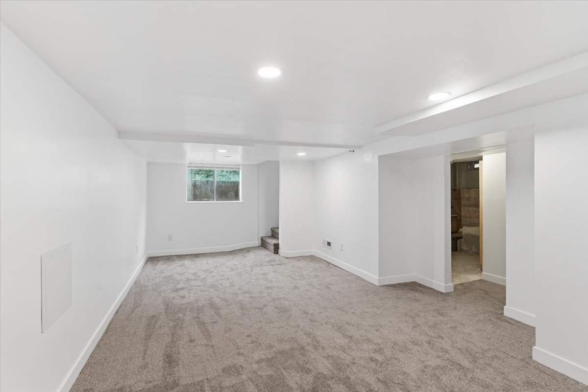 Below grade area featuring light carpet and recessed lighting