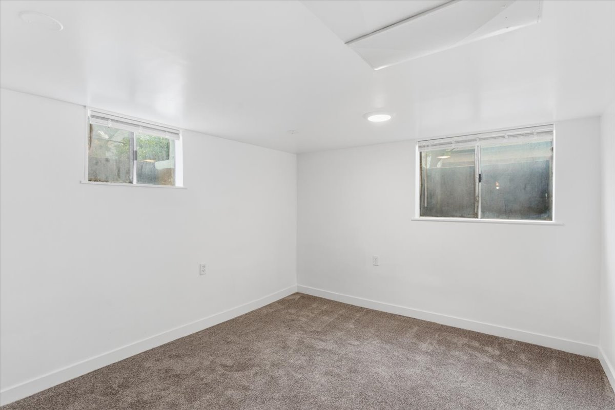 Carpeted spare room with baseboards