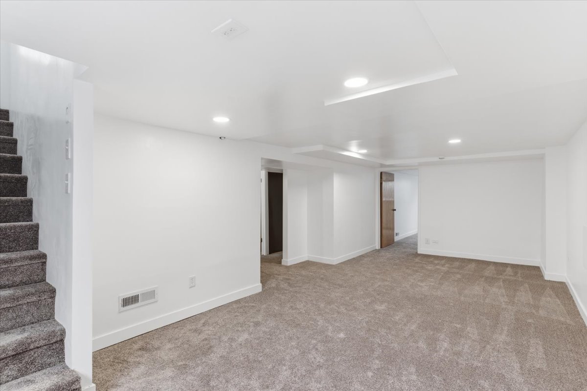 Finished basement featuring recessed lighting and light colored carpet