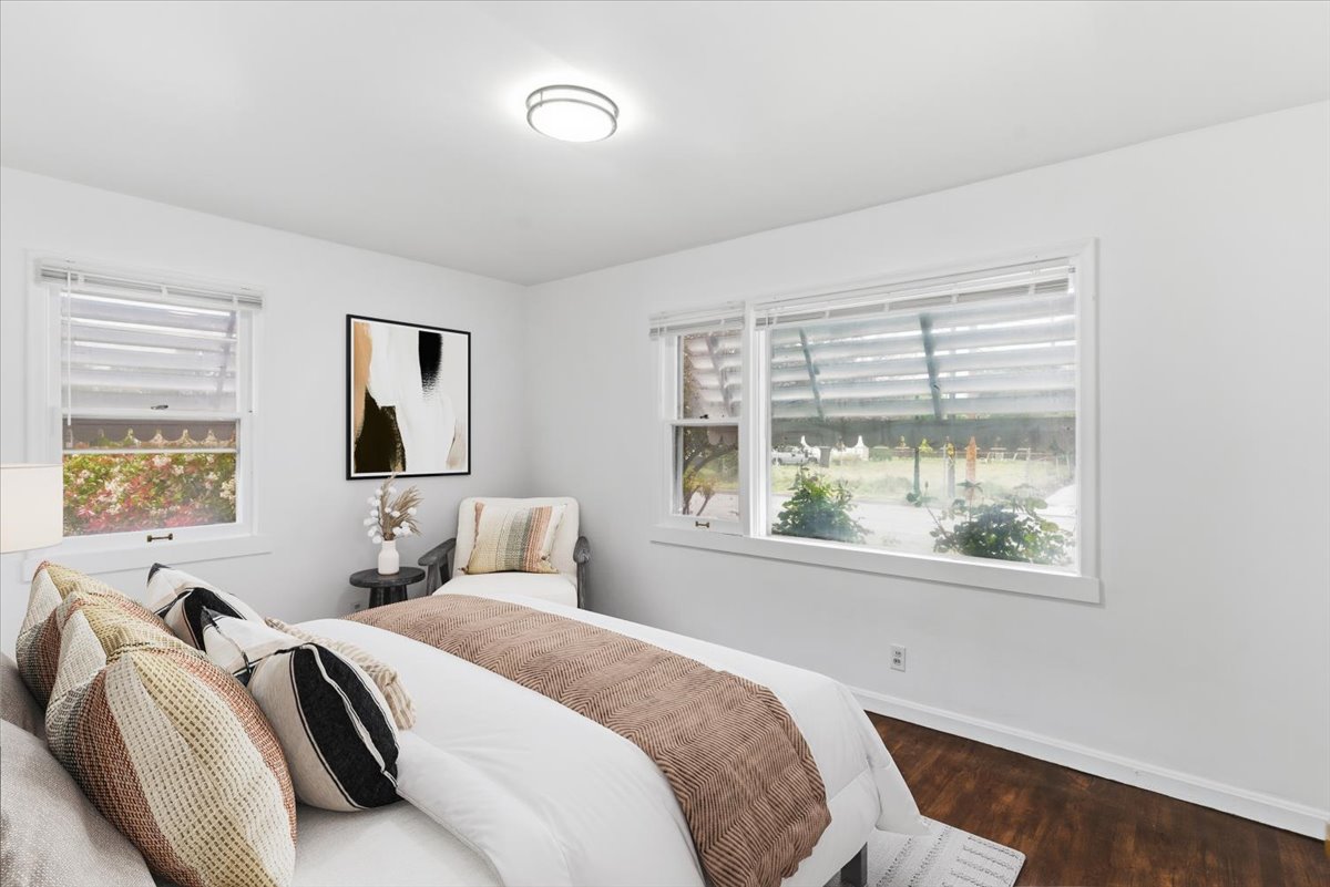 Virtually staged-Bedroom with dark wood-style flooring and baseboards