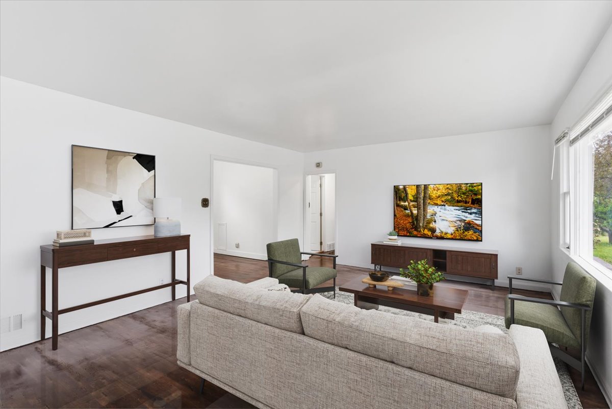 Virtually staged-Living area featuring dark wood-style flooring