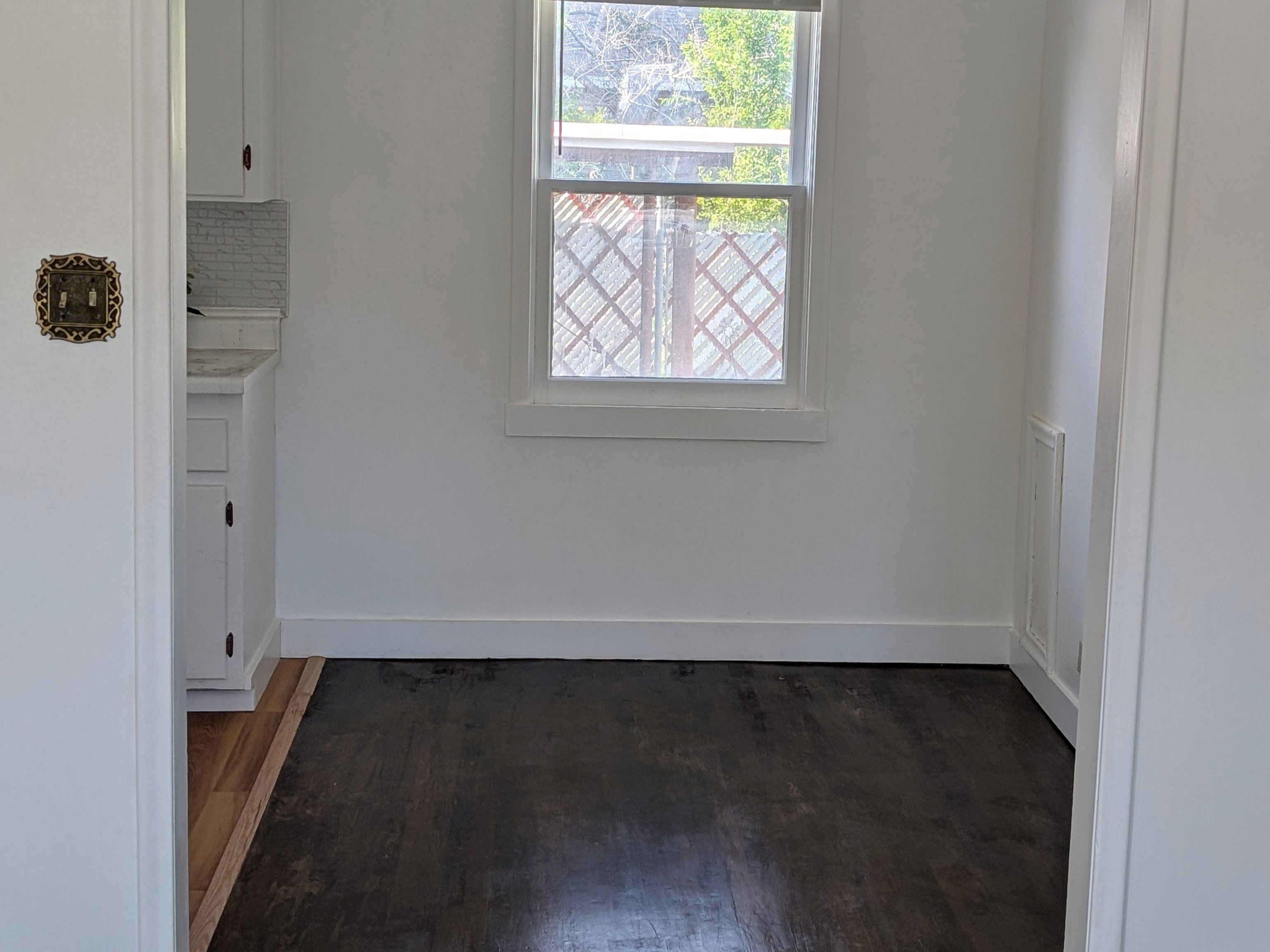 Unfurnished dining area with dark wood-type flooring