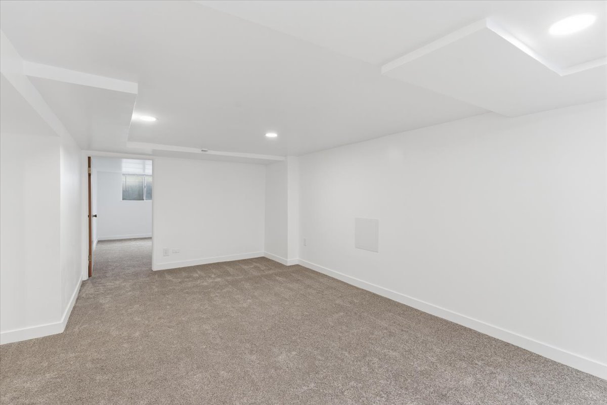 Finished below grade area with recessed lighting and carpet flooring