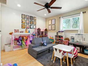 Rec room with light wood-style floors, recessed lighting, and ceiling fan