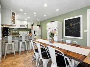 Dining area featuring recessed lighting and a textured ceiling